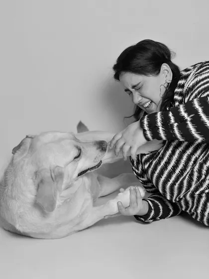 The playful roughhousing between a pet and their person is a beautiful thing to witness. This black and white photo freezes a moment of pure, unscripted fun.