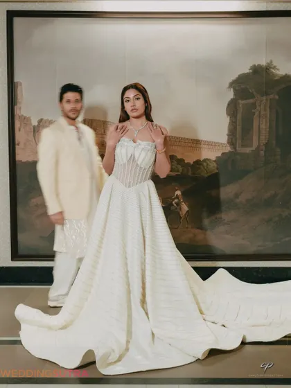 An artistic portrait using a shallow depth of field to create a dreamy, romantic effect. The bride is in sharp focus while the groom is a soft presence, adding a creative touch to the image.