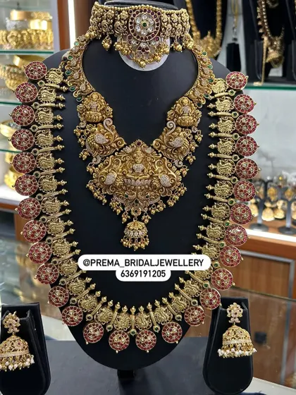 Another view of the grand red Kemp stone bridal set with Lakshmi motifs.