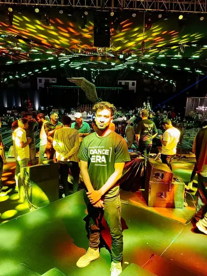 Standing on the stage is where I feel most at home. This photo was taken at a large-scale dance event, and this is the environment of energy and professionalism I bring to your events.