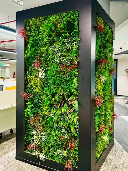 For a corporate client in Hyderabad, we designed and installed this striking vertical garden in their office space. Encased in a black frame, this artificial green wall serves as a vibrant focal point, introducing nature into the workplace without requiring maintenance.