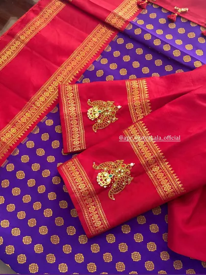 The vibrant red of the blouse makes the gold jewellery embroidery stand out beautifully.