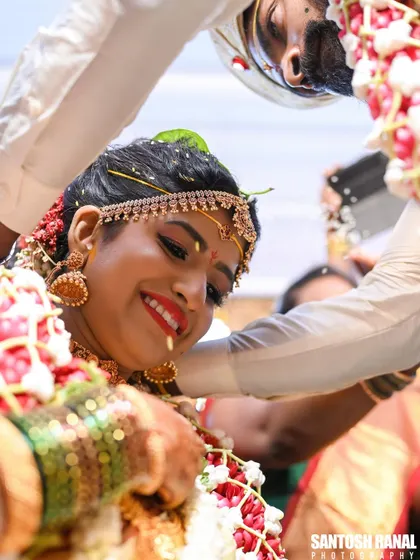 A beautiful, happy close-up of the bride during the akshata ceremony.