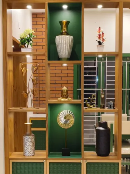A close-up of the custom wooden partition with integrated shelving. The combination of open and closed shelves, along with accent colors and lighting, turns a functional divider into a stunning display piece.