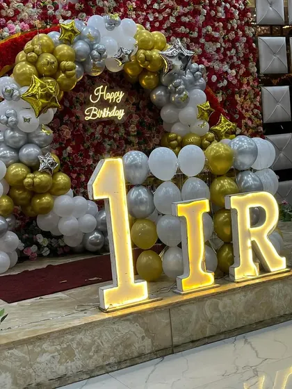 Another angle of the 'IRA' first birthday stage, showing the impressive scale of the marquee letters.