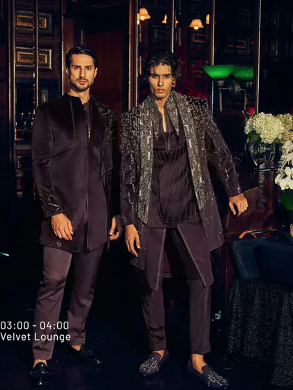 The Velvet Lounge is about owning the spotlight. Here, two men in deep wine velvet ensembles, one with heavy silver embroidery, showcase elegance, unfiltered.