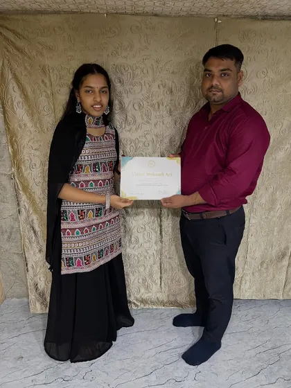 Another one of my students proudly holding her certificate. I make sure every student gets the personal attention they need to become a confident mehandi artist.