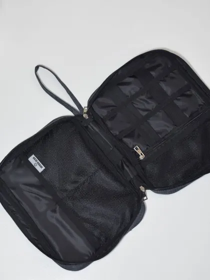 This spacious tech pouch offers multiple mesh pockets and compartments to keep all your gadgets and accessories organized.
