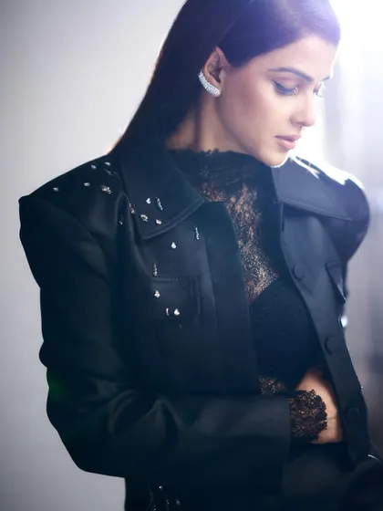 A focus on craftsmanship. This close-up highlights the delicate embellishments on the shoulder of Genelia's jacket, adding a touch of sparkle.