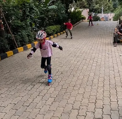 Safety first! A young skater is fully geared up with a helmet and pads, ready to roll with confidence.