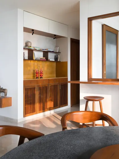 An alcove in an entryway, featuring a custom teak cabinet with a Jaisalmer stone top. I design these small moments to be both beautiful and practical, offering storage and a surface for art and objects.
