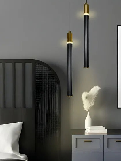 A pair of these slim pendants creates a sophisticated and balanced look in a modern bedroom.