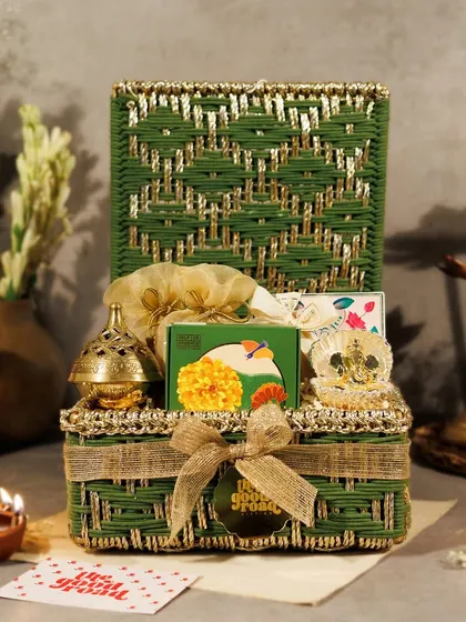 Our green Diwali hamper, all tied up and ready to go. The burlap ribbon and branded tag add a rustic yet elegant finishing touch to this festive gift.