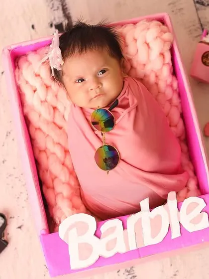 Even in a fun 'Barbie' setup, we can capture those beautiful open eyes. This little one is alert and taking in her glamorous surroundings.
