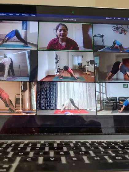 This is what my online morning group classes look like. I can see everyone's alignment and give personalized cues, even on Zoom. We work on poses like the downward dog, ensuring you get the benefits of a studio class from the comfort of your home.