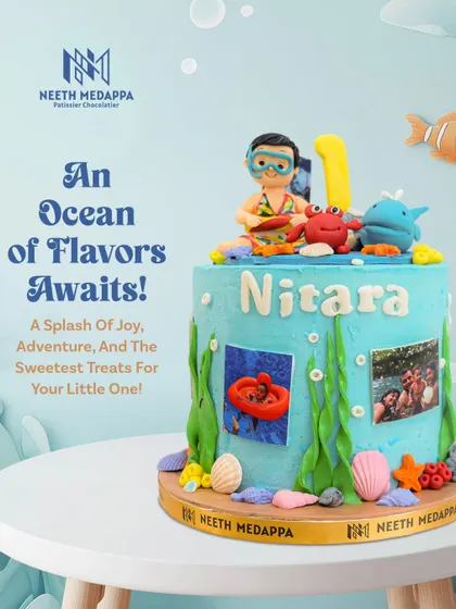 An ocean of flavors awaits! This underwater-themed cake for Nitara's first birthday features sea creatures, shells, and even edible photos for a personal touch.