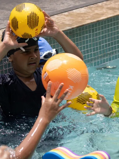 Fun and games with a friendly match of water polo. Activities like these help improve water confidence, teamwork, and agility in a playful way.