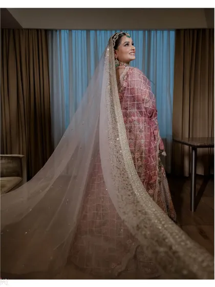 A shot from behind showcasing the bride's long, elegant veil.