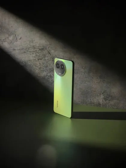 A minimalist shot of the realme C67, using a single beam of light to draw attention to its form and texture.