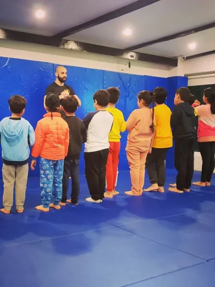 Lining up and listening. Respect and discipline are core to what we do, and it starts from the moment they step on the mat. This is a key part of their martial arts journey.