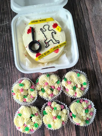 A very unique request for a forensic science fan. This bento cake features a "crime scene" with caution tape, and it came with a side of pretty floral cupcakes.