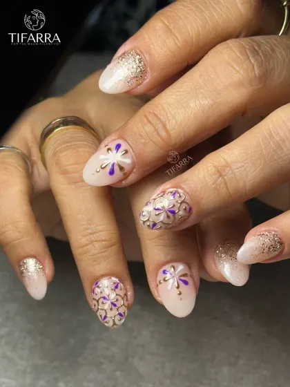 Every bloom is hand-drawn. This intricate design features purple and white floral patterns outlined in raised gold chrome for a stunning mosaic effect.