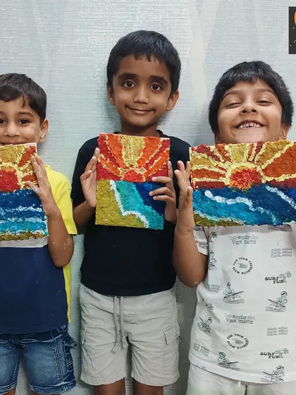 These three friends proudly present their textured paper mache seascapes. This project allowed them to explore a new medium while creating a beautiful sunset scene.
