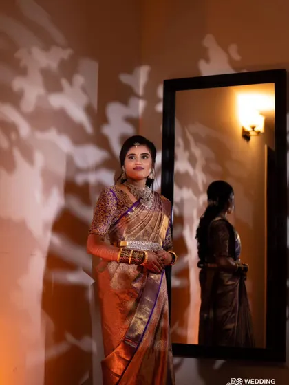 This reception look for Divya was all about creating a dramatic and memorable style. The warm lighting highlights her glowing skin and the rich texture of her silk saree.