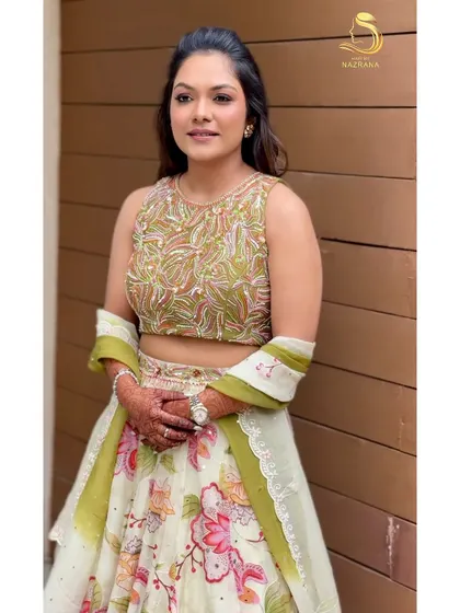 A portrait of the beautiful bride, her floral hairstyle adding a touch of romance to her Mehendi look.