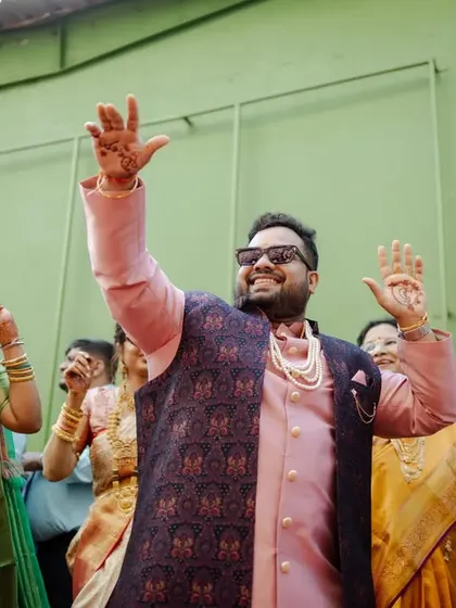 The groom dancing with his family and friends during the baraat, a moment of pure, uninhibited joy.