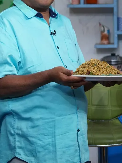 We believe presentation is just as important as taste. Here, one of our team members proudly holds a plate of freshly prepared rice, ready to be served to guests.