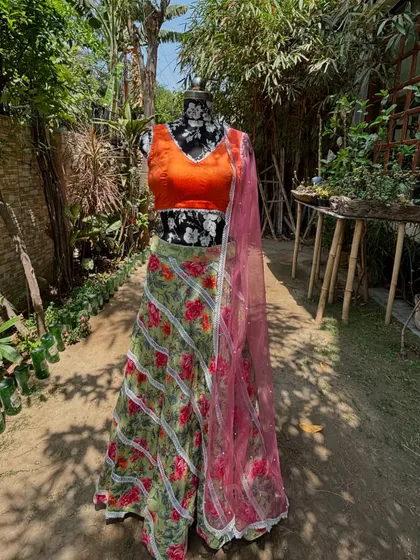 The full view of the floral mehendi lehenga. The pink net dupatta adds another layer of color and fun.