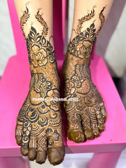 I also create beautiful mehendi designs for feet. This floral design covers the entire foot with bold flowers and delicate leafy vines extending up the ankle, perfect for completing your festive look.