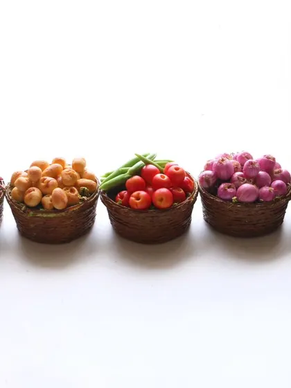 A row of five miniature vegetable baskets, showing the variety of creations.