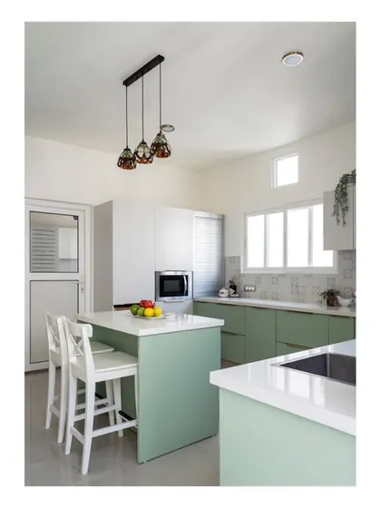 A view of the kitchen transformation, showing the new island and fresh color palette. The space is now a mellow and relaxed hub for the family.