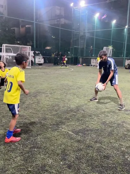 An advanced Under-9 player practices receiving the ball from a coach. This drill helps improve first touch and control.