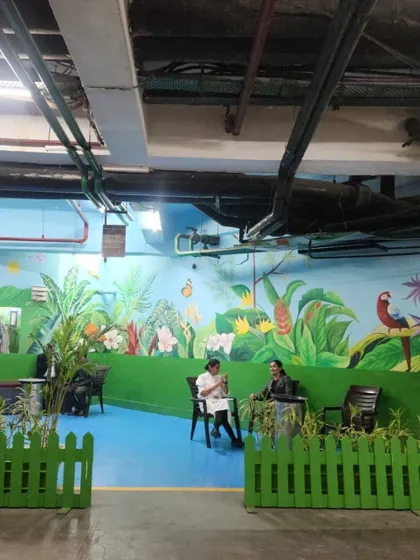 A wide view of our jungle-themed mural in a designated smoking area at the Leela Ambience Hotel. The vibrant artwork turns a functional space into a tropical oasis.