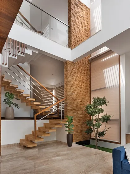 The multi-level staircase in the Cube House is a central feature, visible from the living area. Its open design ensures that light from the skylight above filters down through the different floors of the home.