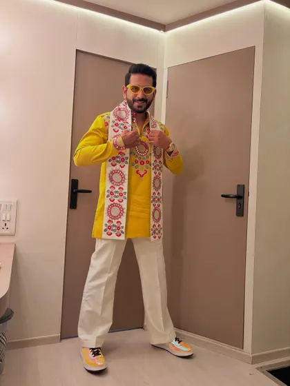 A bright yellow kurta paired with an embroidered scarf for a Garba night. The outfit is designed for energy, movement, and celebrating the festival in style.
