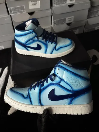 A pair of Nike Air Jordan 1 Mids with a cool blue cartoon effect, using different shades to create depth.