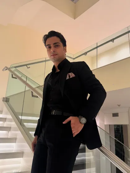 A confident pose that reflects the finesse I bring to my work. My style is an extension of the curated, high-quality experience I provide.