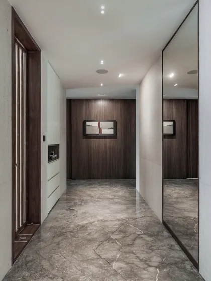 Corridors are not just transitional spaces; they are opportunities for design. Here, I used polished marble flooring and wood paneling to create a gallery-like passage that feels clean and precise.