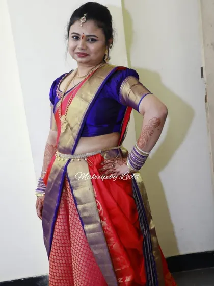A client styled in a traditional half saree for her engagement. The look is perfect for pre-wedding functions, combining tradition with youthful energy.