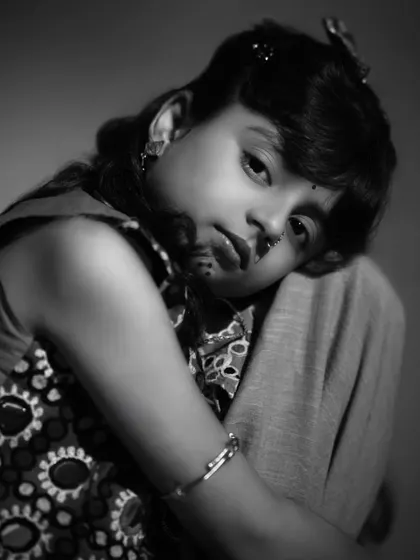 A close-up black and white portrait that feels intimate and soulful. This shot captures a quiet, thoughtful moment, showcasing the depth and emotion she can convey.