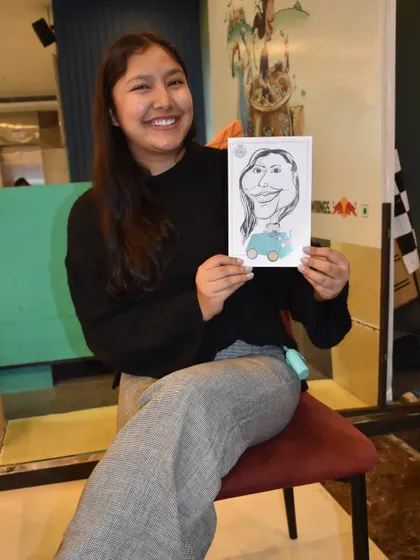 A collaboration with Redbull, bringing my caricature art to their event. This guest is happy with her unique, branded souvenir.