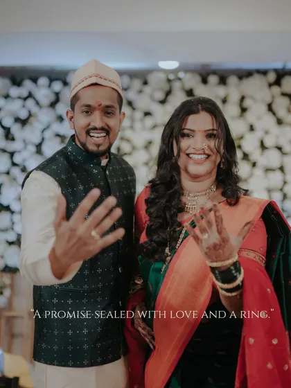 They said yes! The couple joyfully shows off their engagement rings, their smiles radiating happiness. A perfect shot to announce the beginning of their forever.
