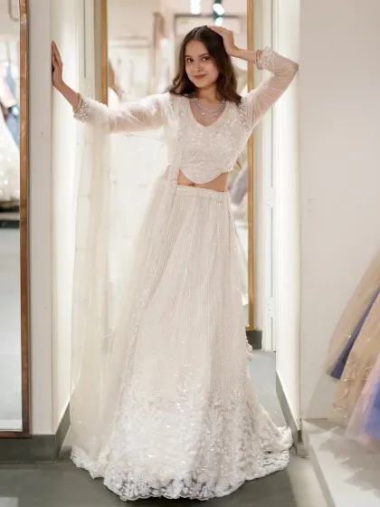 Wearing what moonlight would look like if it were an outfit. A full shot of the ethereal white sequin lehenga, perfect for a reception or engagement party.