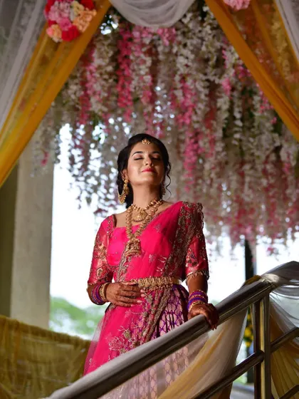 A stunning, artistic shot of Tanu on the stairs, with the light catching her joyful expression and gorgeous pink outfit.