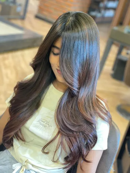 Another angle of this beautiful layered cut, showing off the incredible shine and dimension. The soft layers and styling create a healthy, polished look.