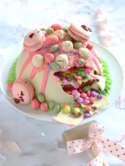 The best part of our Piñata Cake is the moment it breaks open. It’s a perfect, interactive centerpiece for a child's birthday party, combining a delicious red velvet cake with the excitement of a surprise.
